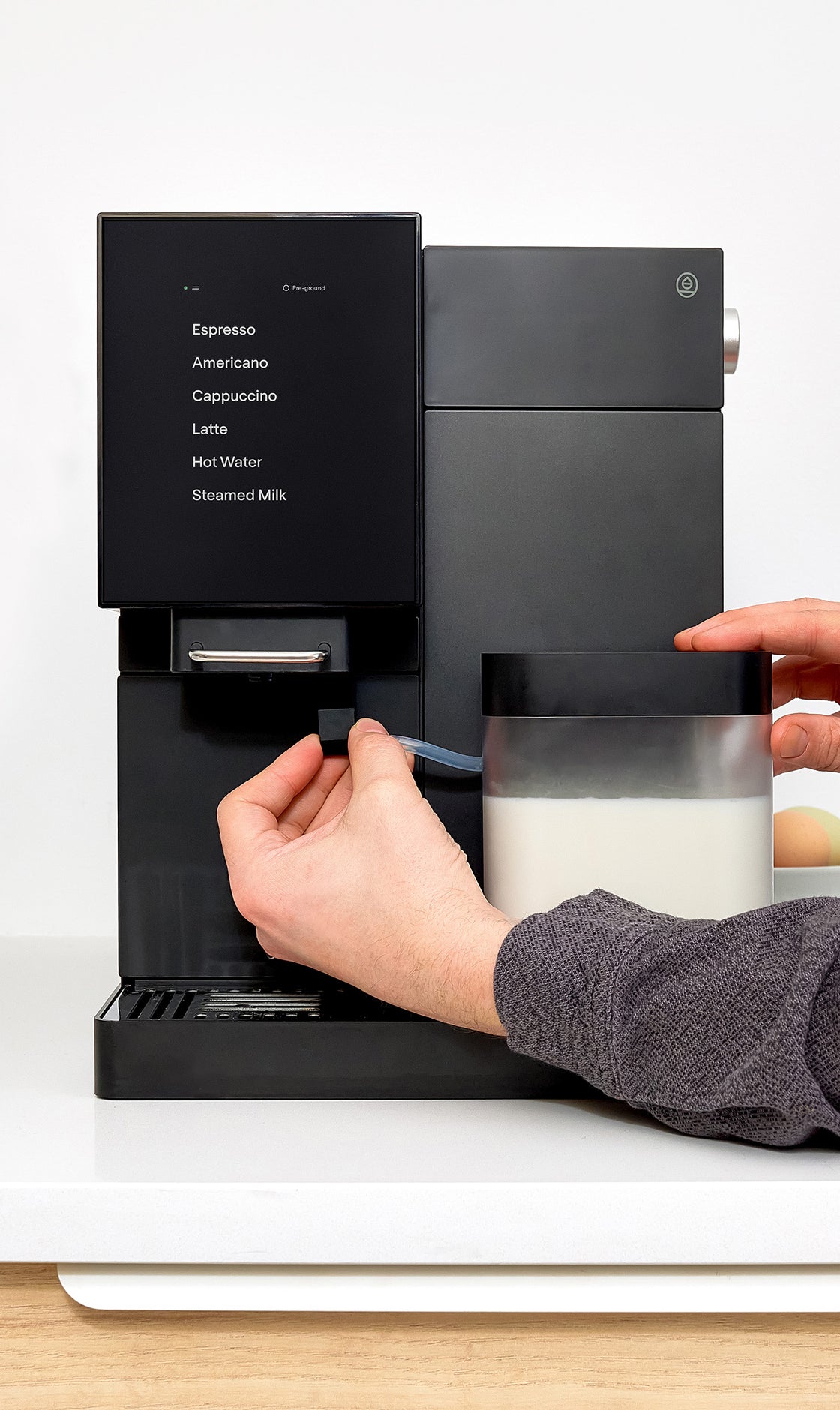 A person attaching the Milk carafe to the TK-02