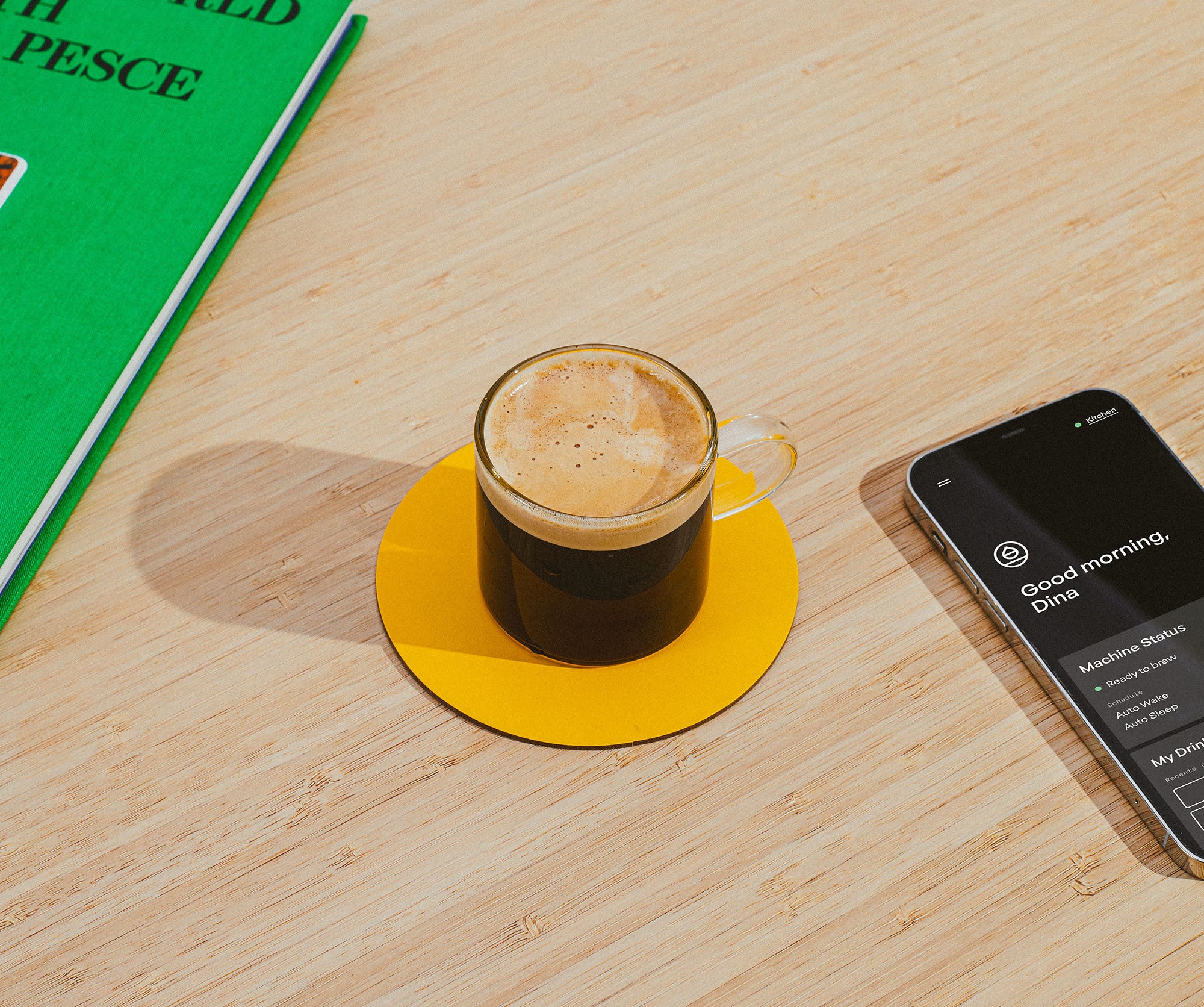 A picture of an Espresso on a yellow coaster