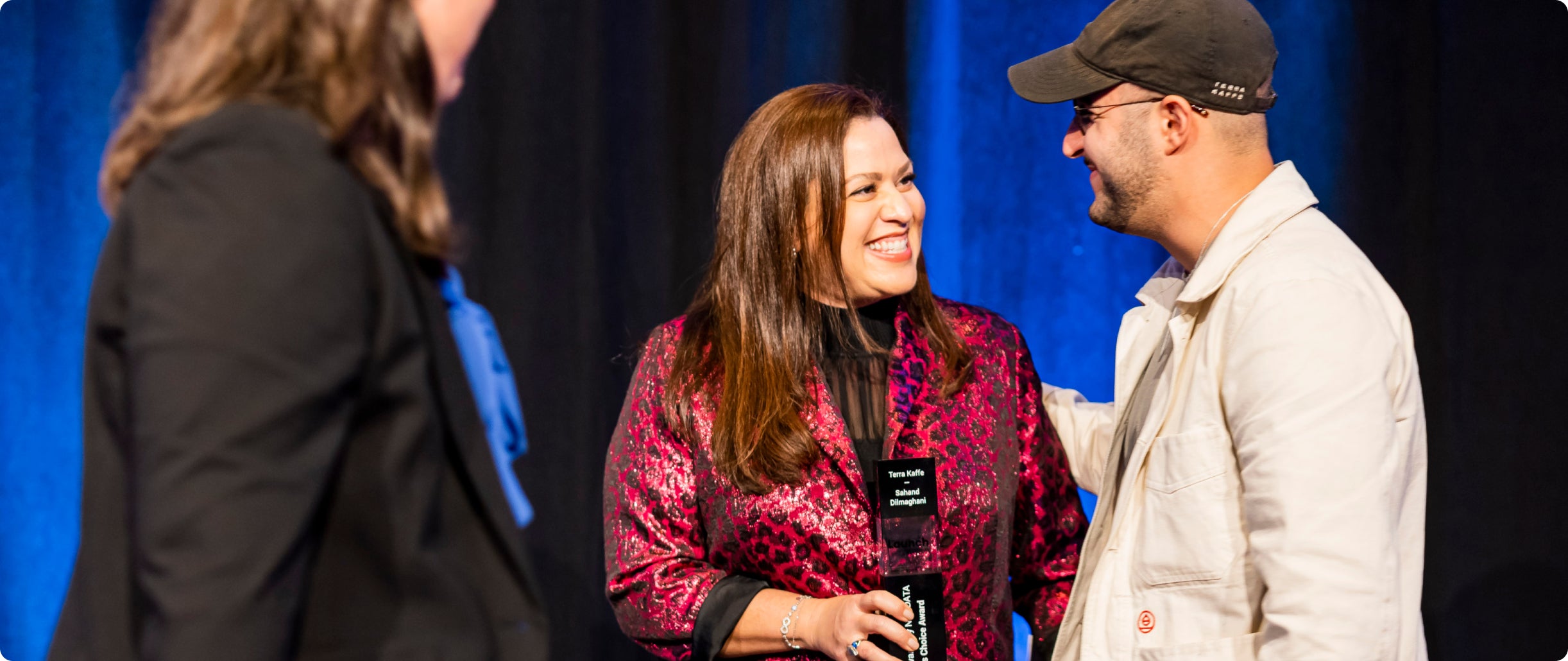 Terra Kaffe | Man receiving an award from a woman 