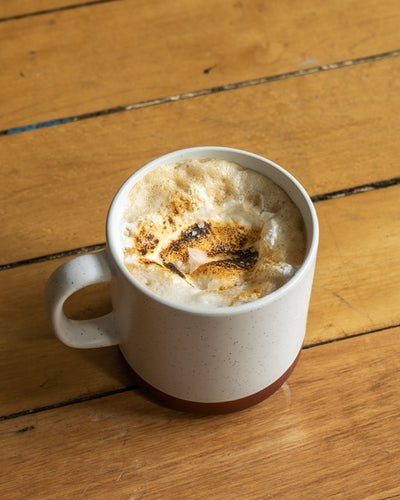 Smore latte in a ceramic mug on a wooden table