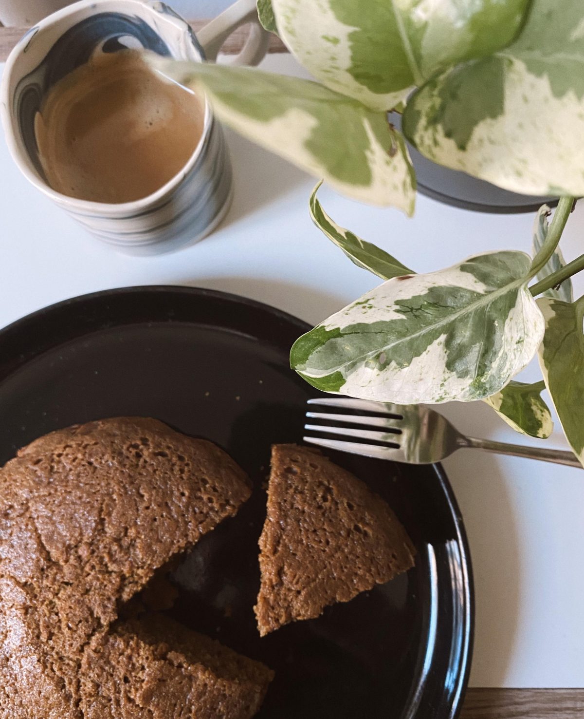  Terra Kaffe | Coffee cake with slice cut out and cup of coffee