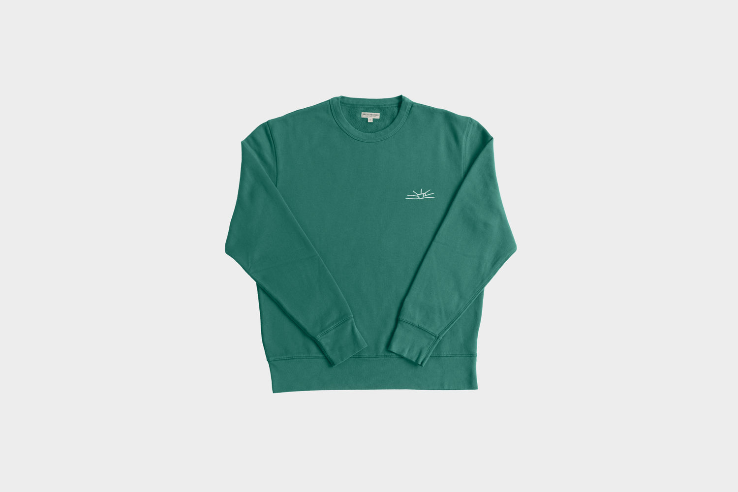 Terra Kaffe | A dark green sweater with a small sunshine design in the top right corner
