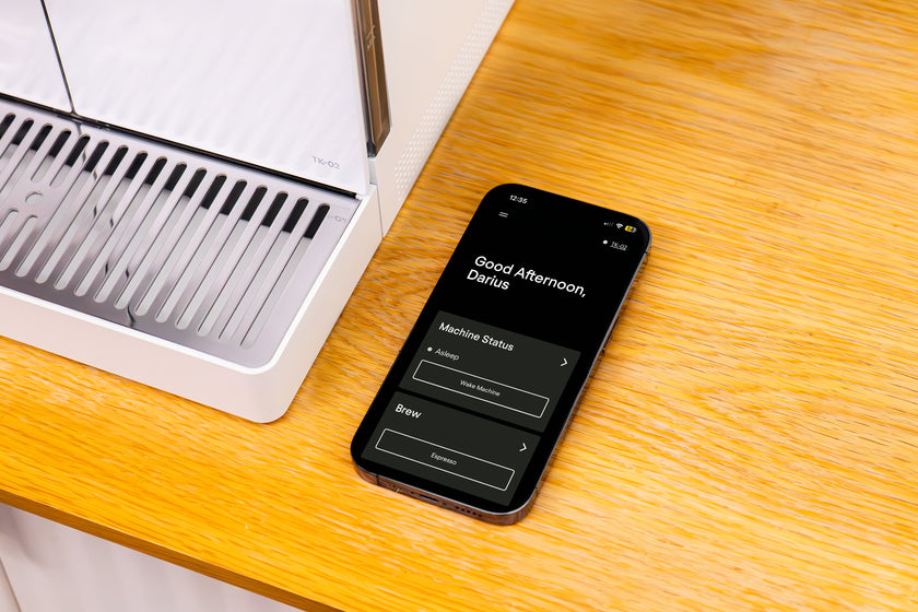 A picture of the Terra Kaffe app on a phone next to the TK-02