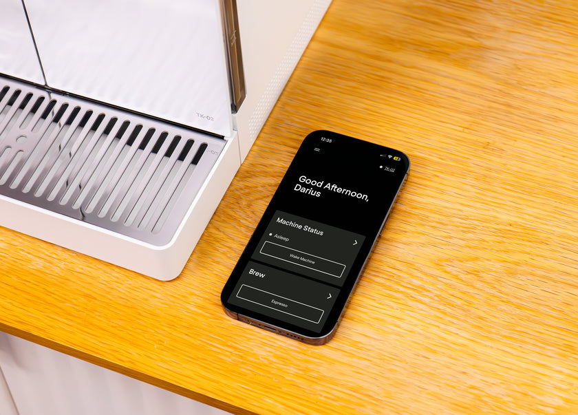 A picture of the Terra Kaffe app on a phone next to the TK-02