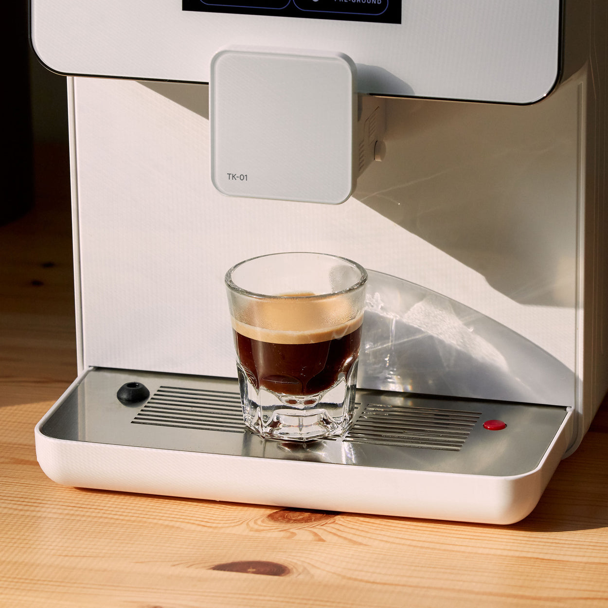 Espresso in a glass sitting on drink tray of TK-01